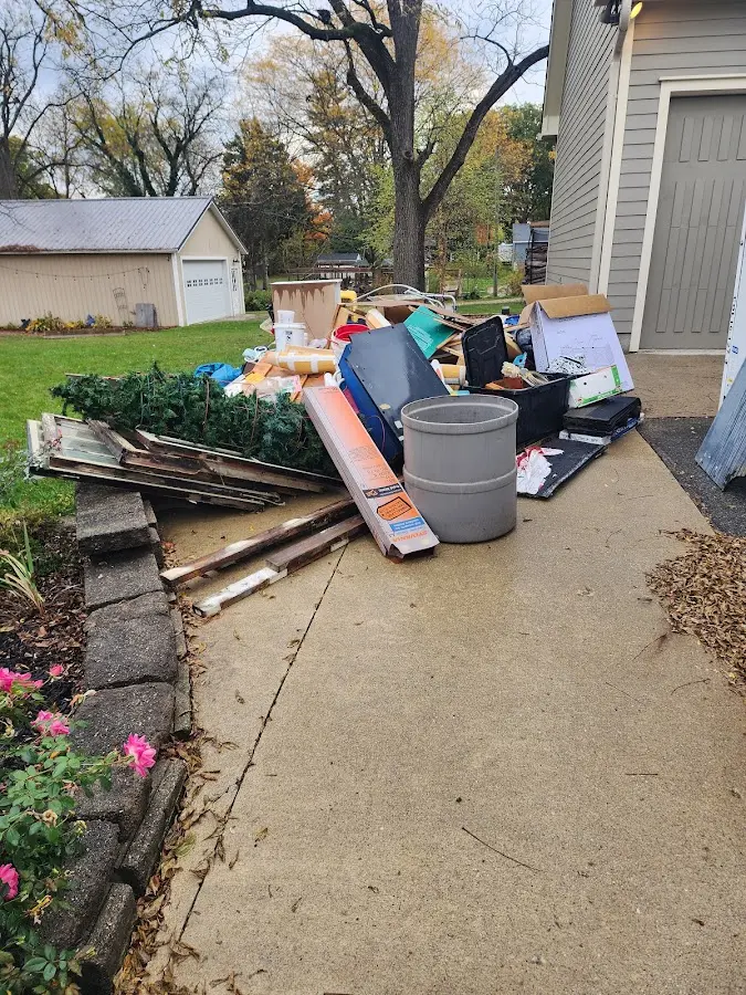 Dumpster being loaded with debris for 3 Yard Dumpster Rental in Fairport